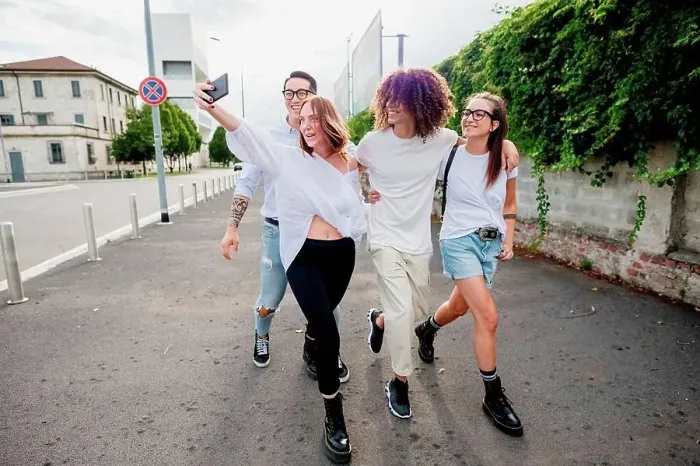Framed Print : Mixed race group of friends hanging out together in town, taking selfie with mobile phone Framed Print : Mixed race group of friends hanging out together in town, taking selfie with mobile phone