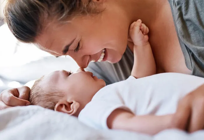 Framed Print : Mom, baby and happy on bed in home for support Framed Print : Mom, baby and happy on bed in home for support