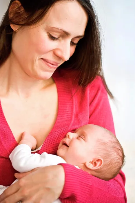 Framed Print : One month old baby sleeping in mother's arms Framed Print : One month old baby sleeping in mother's arms