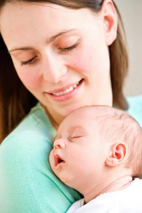 Framed Print : One month old baby sleeping in mother's arms Framed Print : One month old baby sleeping in mother's arms