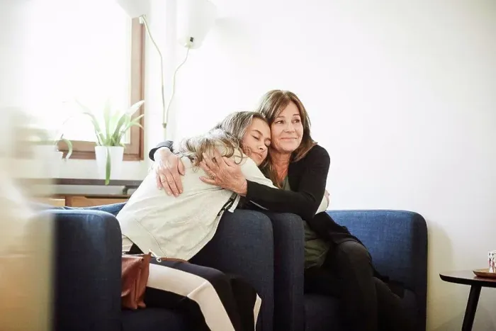 Framed Print : Mother and daughter embracing while sitting at wellness center Framed Print : Mother and daughter embracing while sitting at wellness center