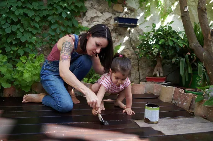 Framed Print : mother and daughter enjoy painting the wood floor together Framed Print : mother and daughter enjoy painting the wood floor together