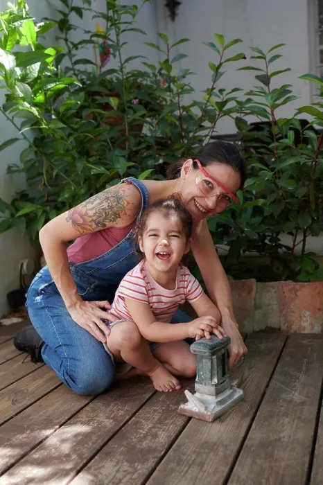 Framed Print : mother and daughter look at the camera sanding the wood on the floor Framed Print : mother and daughter look at the camera sanding the wood on the floor