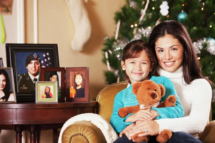Framed Print : Mother holding daughter on lap at Christmas
