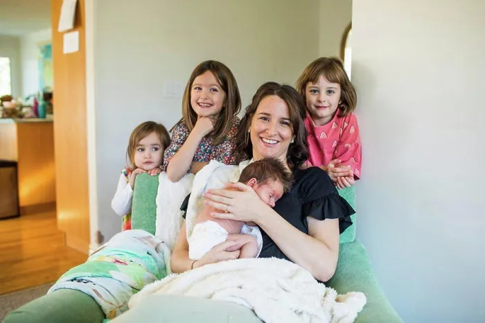 Framed Print : Mother of four holding her newborn baby Framed Print : Mother of four holding her newborn baby