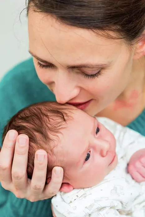 Framed Print : Mother holding her two week old baby boy Framed Print : Mother holding her two week old baby boy