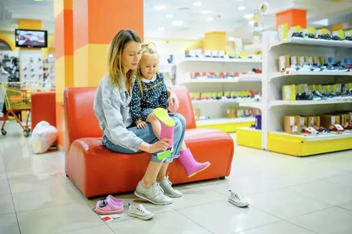 Framed Print : Mother and little daughter buying shoes in kid’s store Framed Print : Mother and little daughter buying shoes in kid’s store