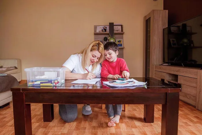 Framed Print : Mother and son drawing together at home