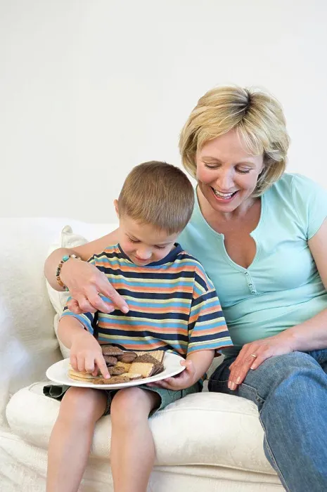 Framed Print : Mother and son eating biscuits