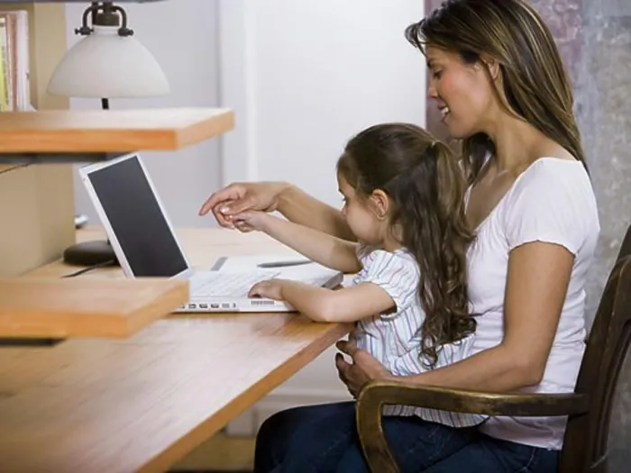 Framed Print : Mother and young daughter working on laptop computer Framed Print : Mother and young daughter working on laptop computer