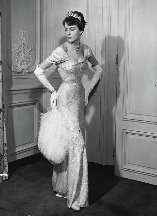 Framed Print : Moulded over the figure, Mattli's white and silver lame court dress falls into a graceful train at the back