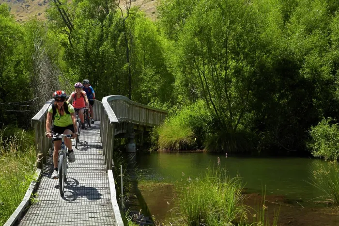 Framed Print : Mountain bikers on the wetlands boardwalk on the Lake Hayes Circuit