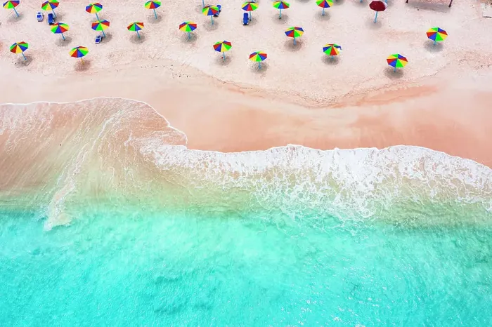 Framed Print : Multi colored umbrellas on tropical beach washed by waves of Caribbean Sea