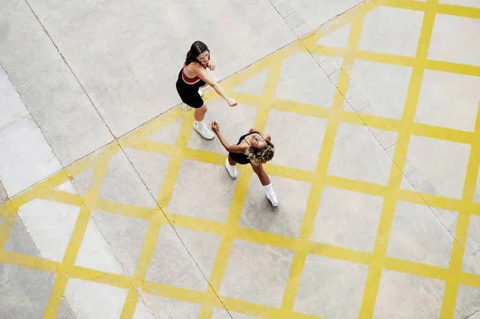 Framed Print : Multi-ethnic female friends boxing on yellow patterned footpath Framed Print : Multi-ethnic female friends boxing on yellow patterned footpath