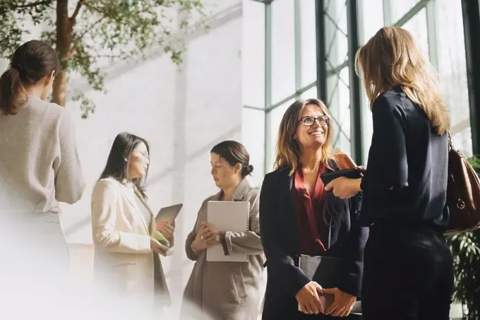 Framed Print : Multi-ethnic female professionals talking at conference event Framed Print : Multi-ethnic female professionals talking at conference event