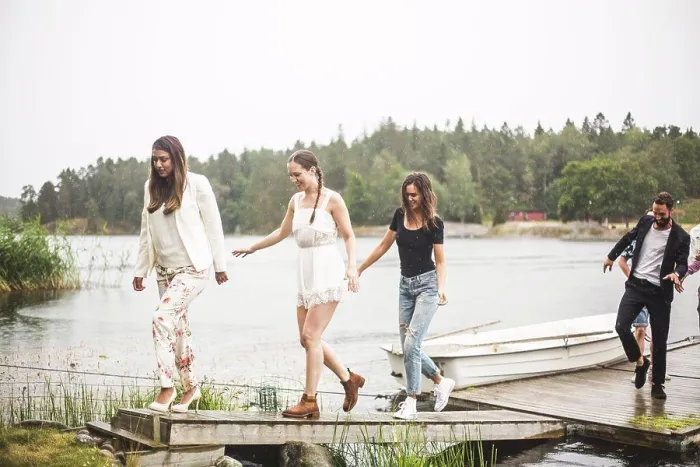 Framed Print : Multi-ethnic friends walking on jetty over lake during weekend getaway Framed Print : Multi-ethnic friends walking on jetty over lake during weekend getaway