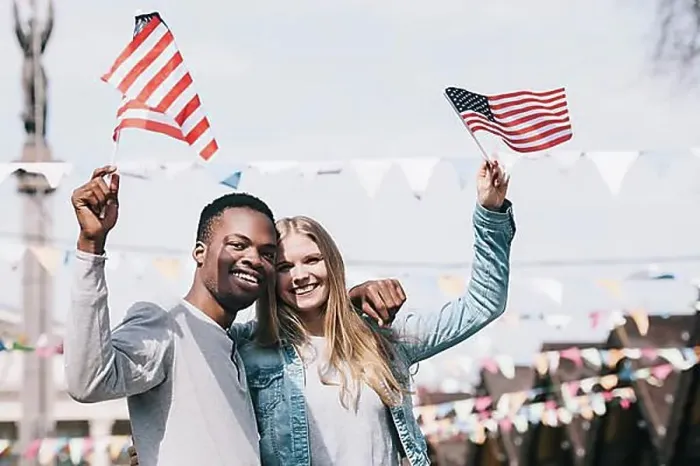 Framed Print : Multiethnic friends holding american flags outstretched hands Framed Print : Multiethnic friends holding american flags outstretched hands