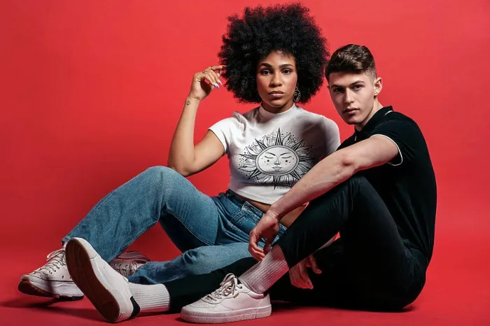 Framed Print : Multiracial couple studio shooting over a red background Framed Print : Multiracial couple studio shooting over a red background