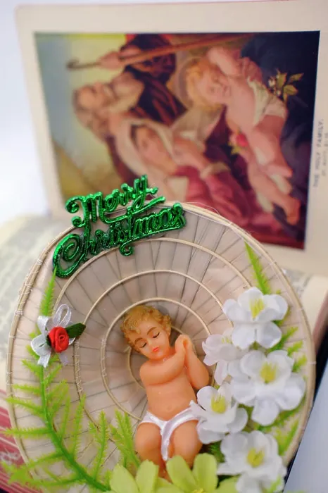 Framed Print : Nativity scene. Baby Jesus in a conical hat and holy bible Framed Print : Nativity scene. Baby Jesus in a conical hat and holy bible