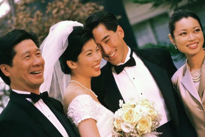 Framed Print : Newlywed couple smiling with their parents Framed Print : Newlywed couple smiling with their parents