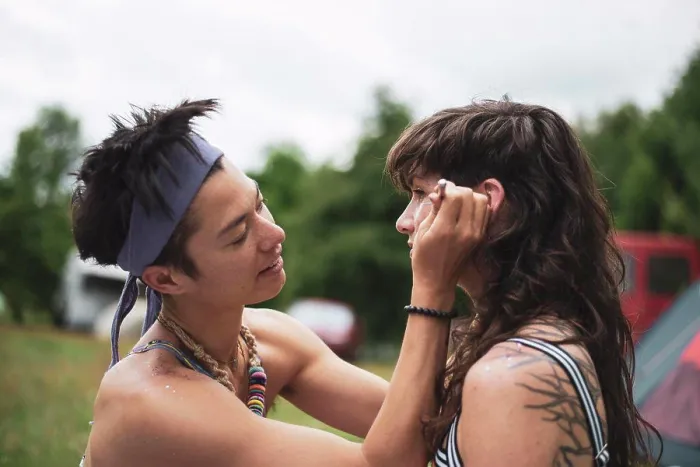 Framed Print : non-binary asian face paints woman with curly hair at festival camp Framed Print : non-binary asian face paints woman with curly hair at festival camp