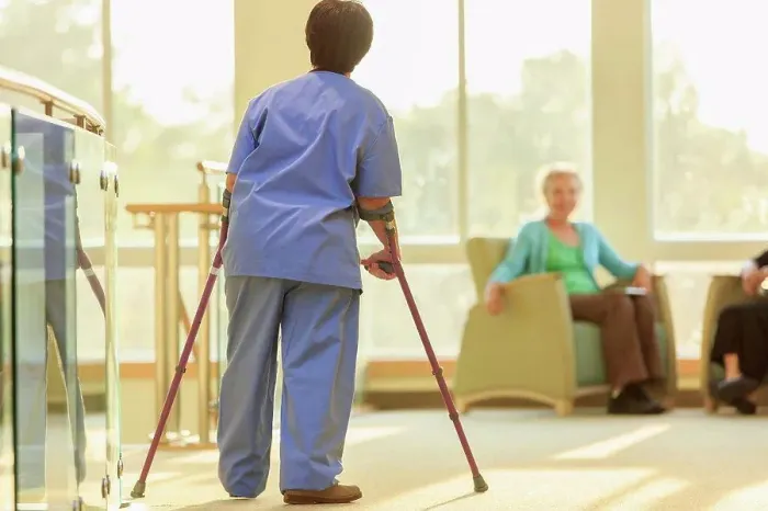 Framed Print : Nurse with Cerebral Palsy walking down the hallway of a clinic with her canes Framed Print : Nurse with Cerebral Palsy walking down the hallway of a clinic with her canes