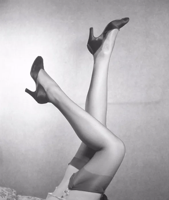 Framed Print : Nylon stockings in the 1940s. A young woman's legs with nylon stockings that fit perfectly is the latest fashion