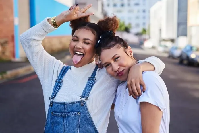 Framed Print : Were off to that white and denim party. two young woman out in the city during the day