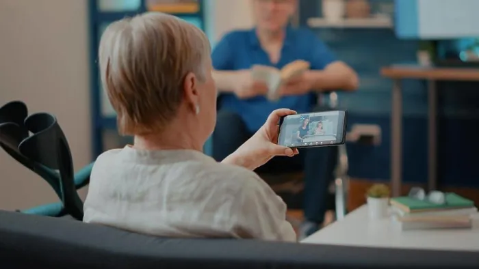 Framed Print : Old woman using smartphone to talk to family in hospital on videocall