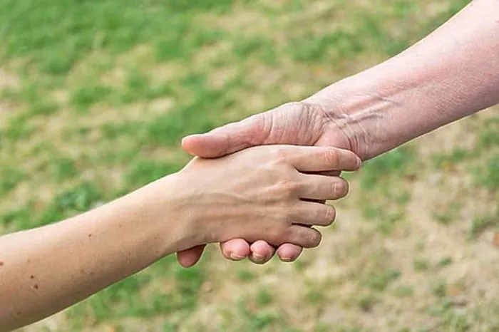 Framed Print : Old and young hands doing handshake Framed Print : Old and young hands doing handshake