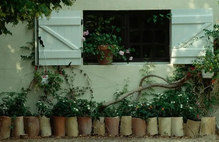 Framed Print : Open white shutters above row of cylindrical pots