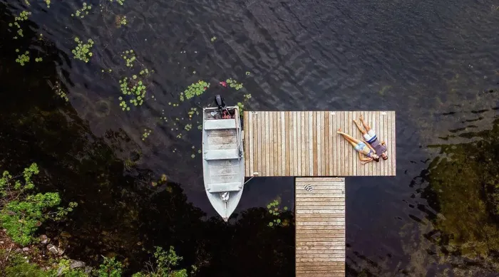 Framed Print : Overhead aerial image of couple laying on a dock together Framed Print : Overhead aerial image of couple laying on a dock together