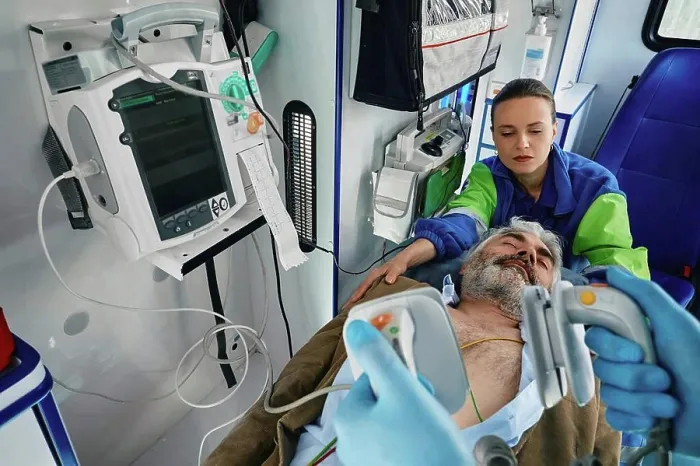 Framed Print : Paramedics treating patient in ambulance