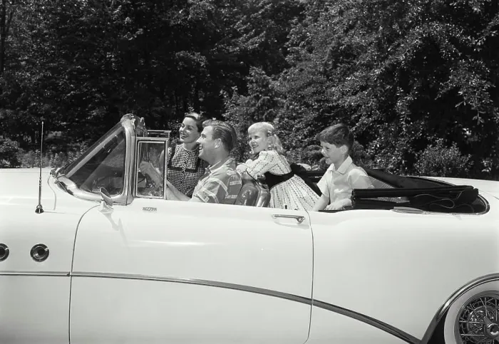 Framed Print : Parents and their children traveling in a car