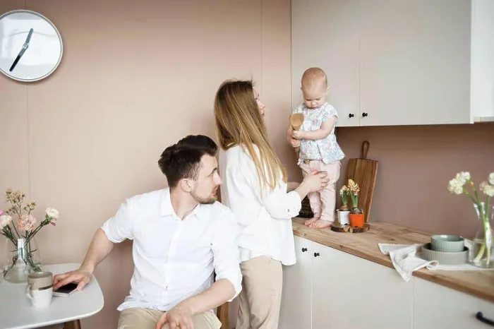 Framed Print : Parents communicate with little child in kitchen during breakfast