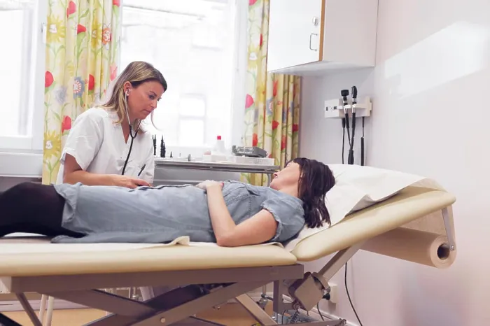 Framed Print : A patient consults with a healthcare professional in a bright medical office