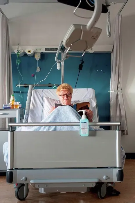 Framed Print : Patient in hospital bed reading magazine Framed Print : Patient in hospital bed reading magazine
