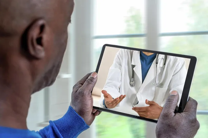 Framed Print : Patient listening to his doctor through the tablet Telemedicine-Patient in front of his doctor 016278_037