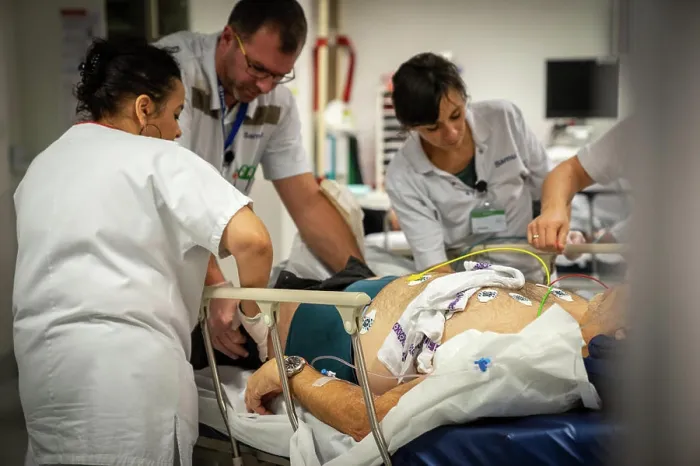 Framed Print : A patient who is not very lucid is placed under electrodes in intensive care to monitor his heart rate