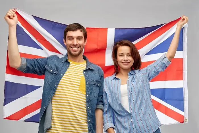 Framed Print : patriotism and national concept - happy couple holding british flag over grey background Framed Print : patriotism and national concept - happy couple holding british flag over grey background