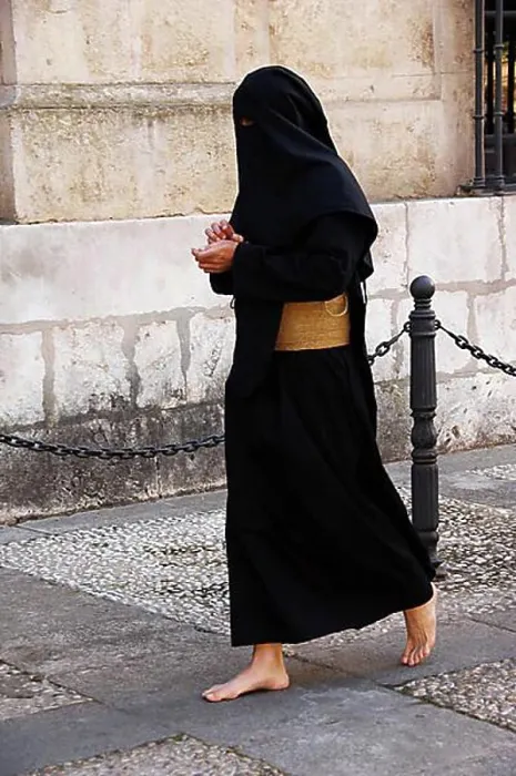 Framed Print : Penitent dressed in black penitential robe (nazareno) on their way to the Semana Santa Framed Print : Penitent dressed in black penitential robe (nazareno) on their way to the Semana Santa