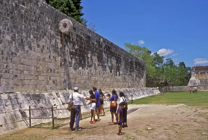 Framed Print : People standing below ancient Mayan Ballgame Hoop in Chichen Itza sport court, Yucatan, Mexico