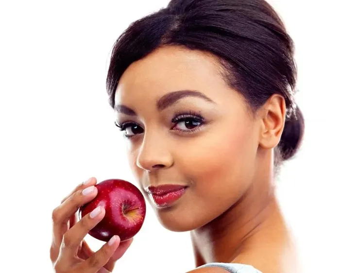 Framed Print : The perfect diet snack. A young woman holding an apple and smiling at the camera Framed Print : The perfect diet snack. A young woman holding an apple and smiling at the camera