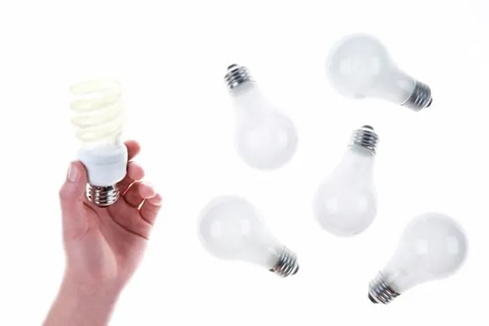 Framed Print : Person Holding Compact Fluorescent Lightbulb near Incandescent Lightbulbs Framed Print : Person Holding Compact Fluorescent Lightbulb near Incandescent Lightbulbs