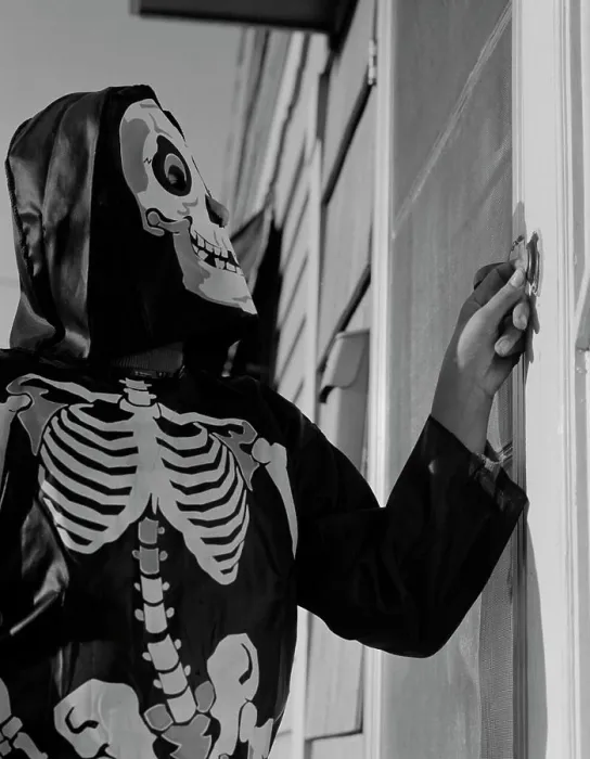 Framed Print : Person ringing doorbell wearing as skeleton