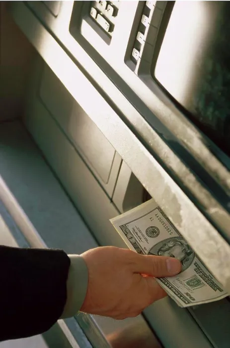 Framed Print : Person withdrawing cash from an ATM Framed Print : Person withdrawing cash from an ATM