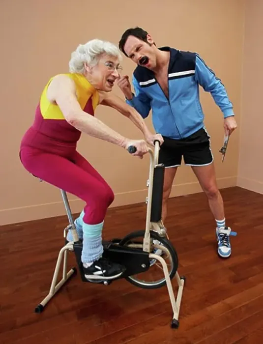 Framed Print : Personal Trainer Encouraging Woman on Exercise Bike Framed Print : Personal Trainer Encouraging Woman on Exercise Bike