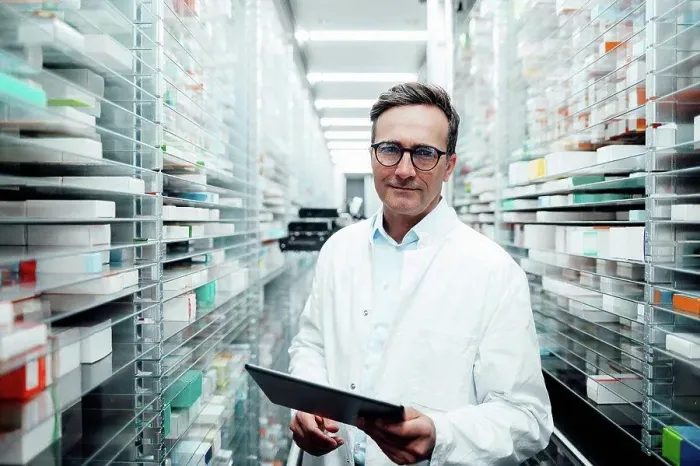 Framed Print : Pharmacist with tablet PC standing in storage room at pharmacy Framed Print : Pharmacist with tablet PC standing in storage room at pharmacy