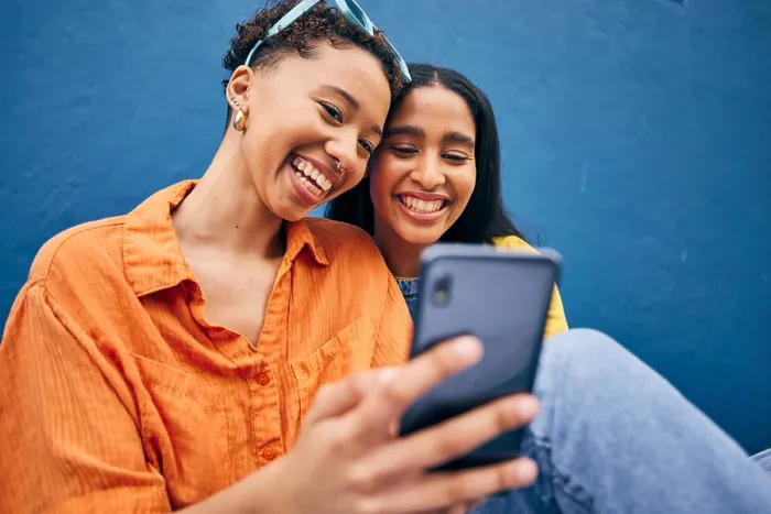 Framed Print : Phone, happy and women in city on blue background for social media Framed Print : Phone, happy and women in city on blue background for social media