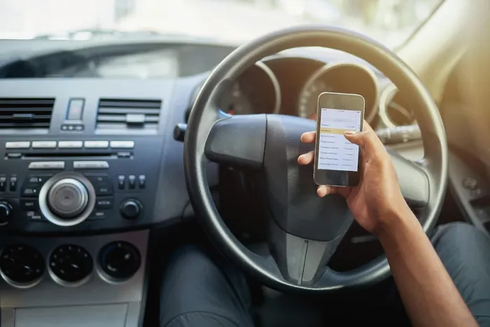 Framed Print : Phone, texting and driving with hands of person on steering wheel with scroll